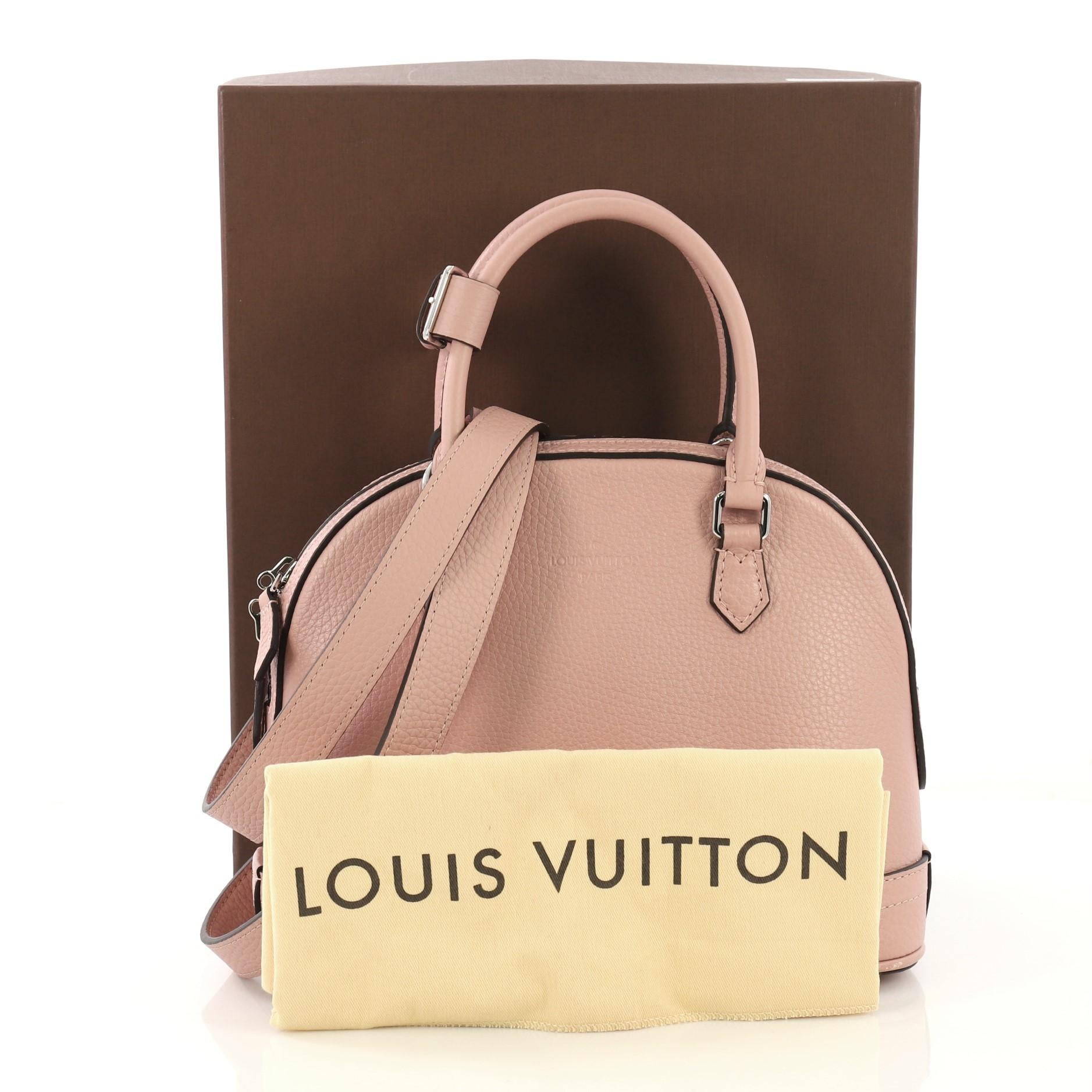 This Louis Vuitton Parnassea Alma Handbag Taurillon Leather PPM, crafted in pink taurillon leather, features dual rolled handles, and silver-tone hardware. Its zip around closure opens to a taupe suede interior with zip and slip pockets.