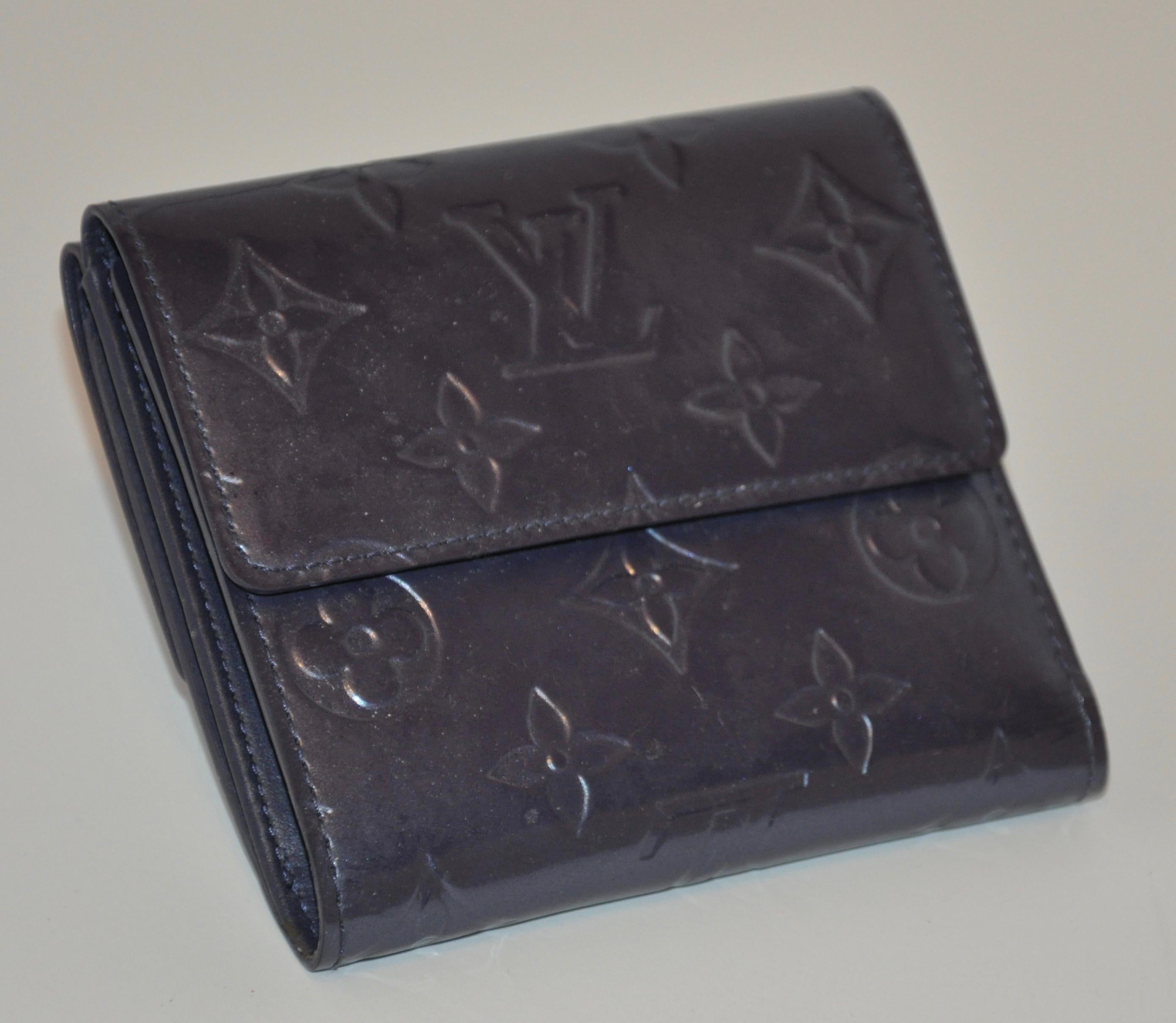 Louis Vuitton's pearl-steel signature monogram credit-card, billfold and change wallet measures 10 inches by 4 3/8 inches when opened. Measurement, when closed are 4 inches by 4 3/8 inches. Made in France.