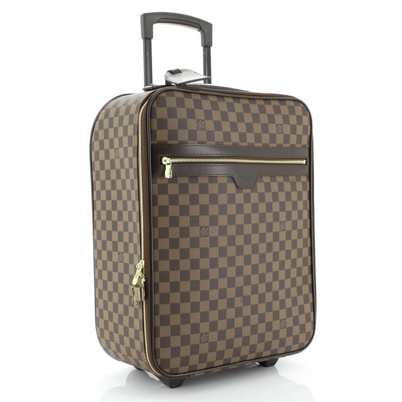 This Louis Vuitton Pegase Luggage Damier 45, crafted in damier ebene coated canvas, features exterior zip pocket, retractable handle with lock button, silent rolling system and gold-tone hardware. Its zip closure opens to a brown nylon and fabric