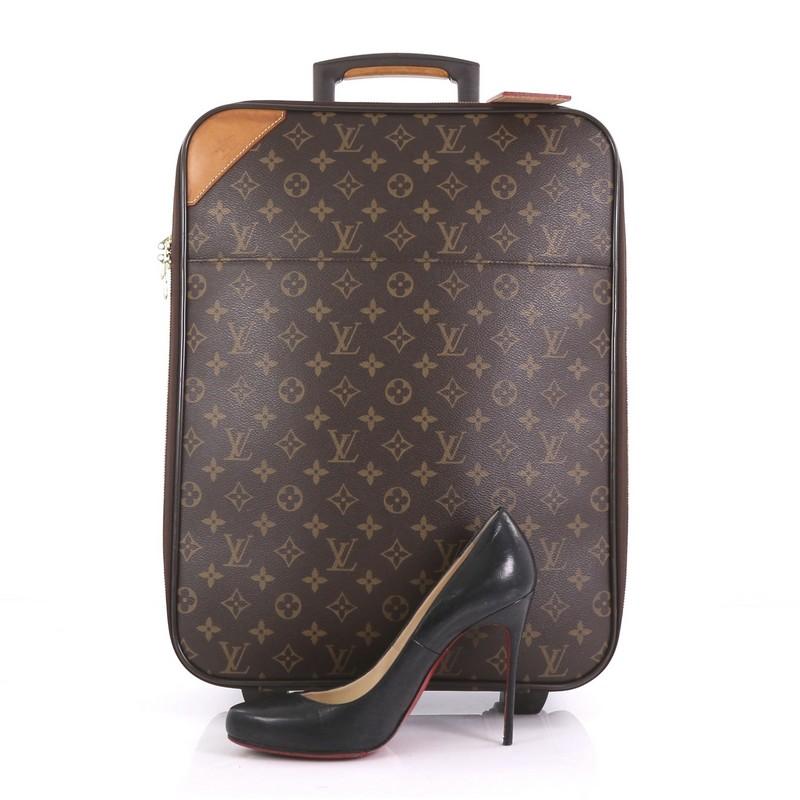 This Louis Vuitton Pegase Luggage Monogram Canvas 45, crafted from brown monogram coated canvas, features a retractable handle with lock button and rolling system, leather trim, and gold-tone hardware. Its all-around zip closure opens to a brown