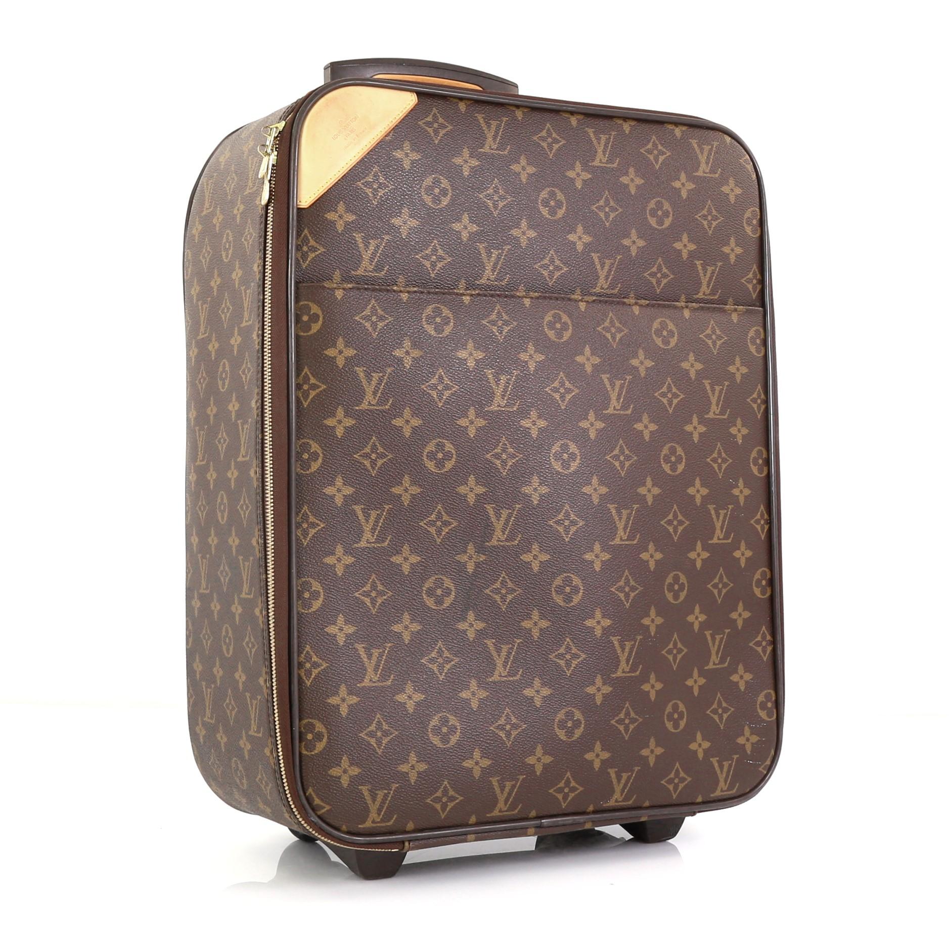This Louis Vuitton Pegase Luggage Monogram Canvas 45, crafted from brown monogram coated canvas, features a retractable handle with lock button and rolling system, cowhide leather trim, and gold-tone hardware. Its all-around zipper closure opens to
