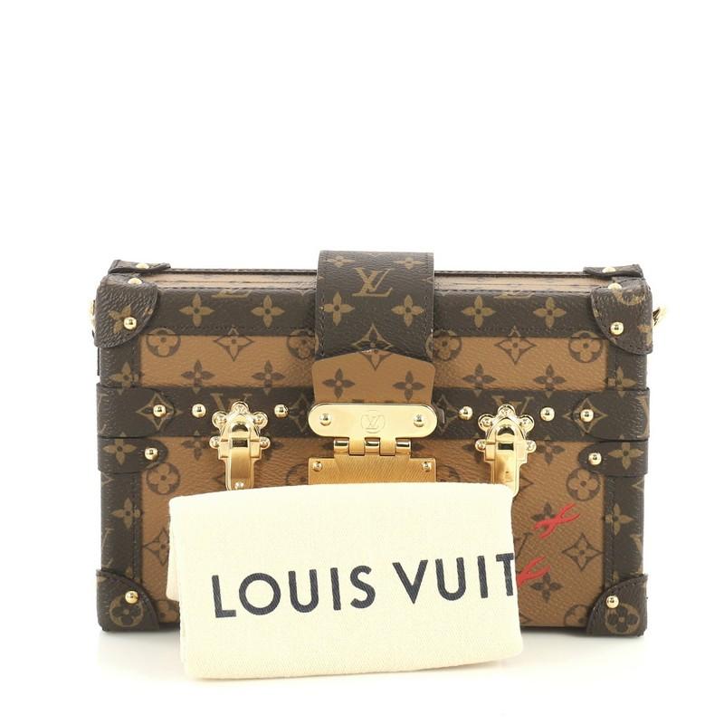 This Louis Vuitton Petite Malle Handbag Reverse Monogram Canvas, crafted from brown reverse monogram coated canvas, features brown monogram coated canvas trim, signature three red crosses, and gold-tone hardware. Its S-lock closure opens to a