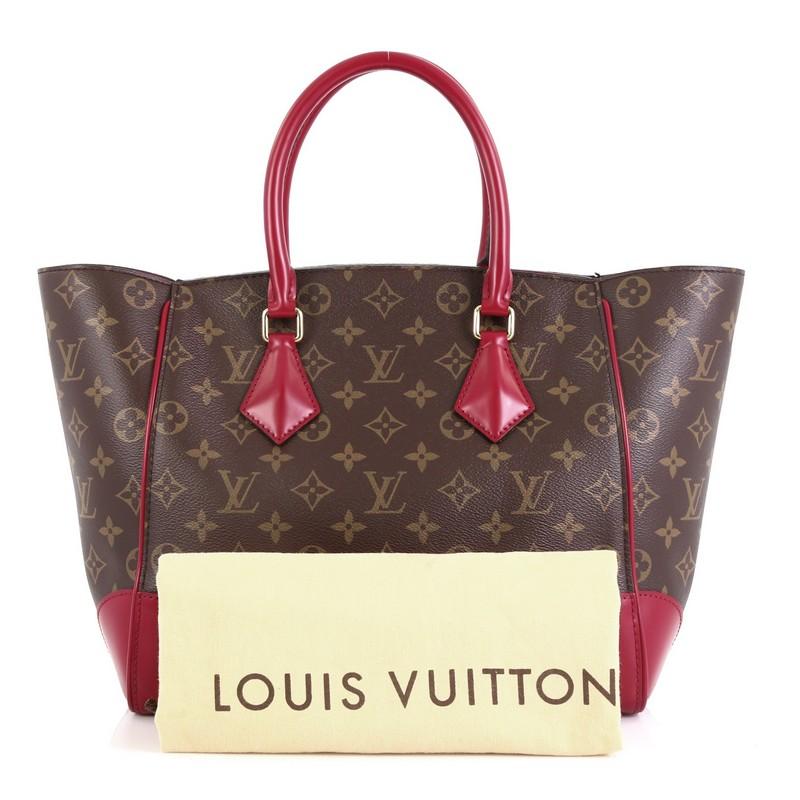 This Louis Vuitton Phenix Tote Monogram Canvas MM, crafted from brown monogram coated canvas, features dual rolled leather handles, leather trim and base corners, and gold-tone hardware. Its wide open top showcases a purple microfiber interior with