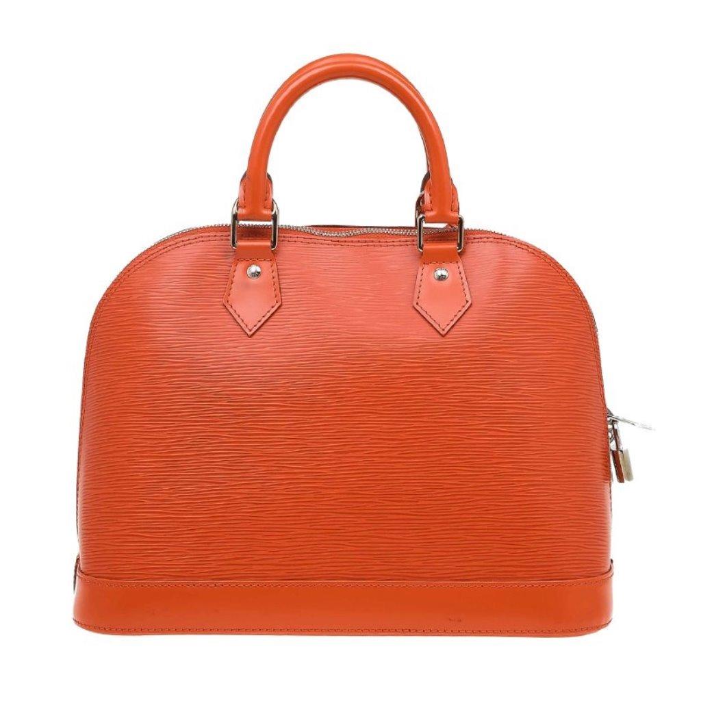 The original design of the Alma bag designed by Gaston Vuitton himself and named after the Alma bridge in Paris. This Louis Vuitton Alma PM bag is made from Epi leather in a bright orange shade. It features two rolled, top handles and silver tone