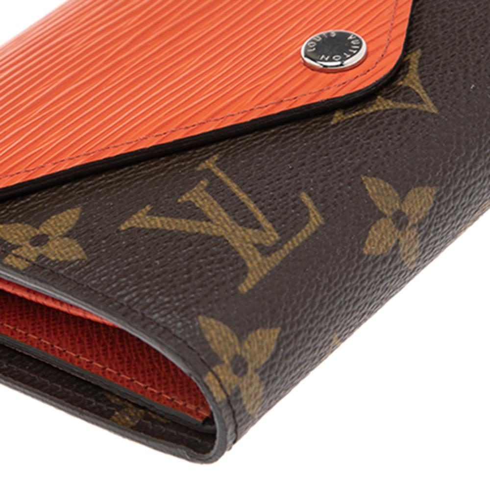 Bringing a blend of remarkable fashion and fine craftsmanship is this compact wallet from Louis Vuitton. The wallet brings a turquoise epi leather flap and a monogram canvas body along with multiple card slots and an interior snap pouch.


