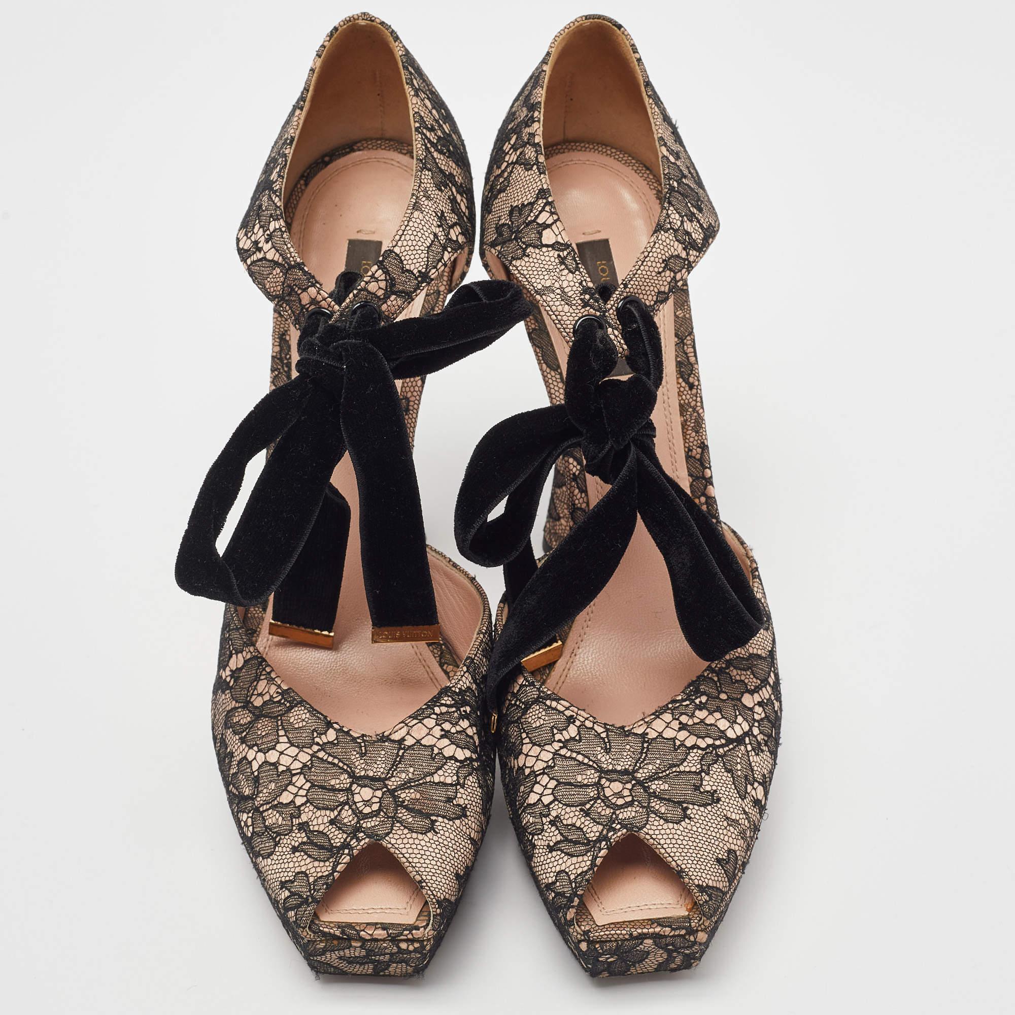 A beautiful pair of lace pumps finished with velvet ties. The pumps by Louis Vuitton feature peep toes with platforms sharply cut at the front. They are lined with leather and lifted on embellished heels.

