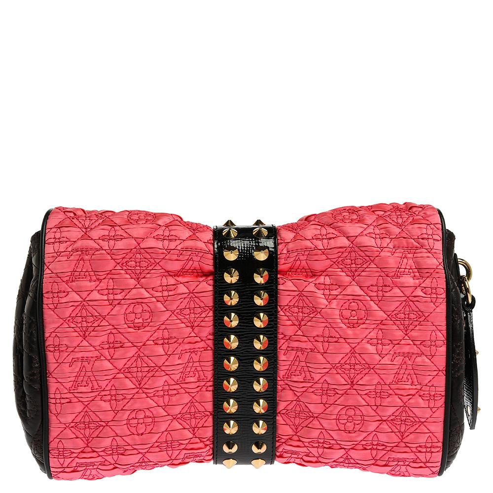 Chic and vibrant, this Louis Vuitton Coquette pochette will look great in your hand. Crafted from pink monogram stitched satin, black leather and Vernis leather, the pochette is accentuated with gold-tone spikes and a lock on the front. This pretty,