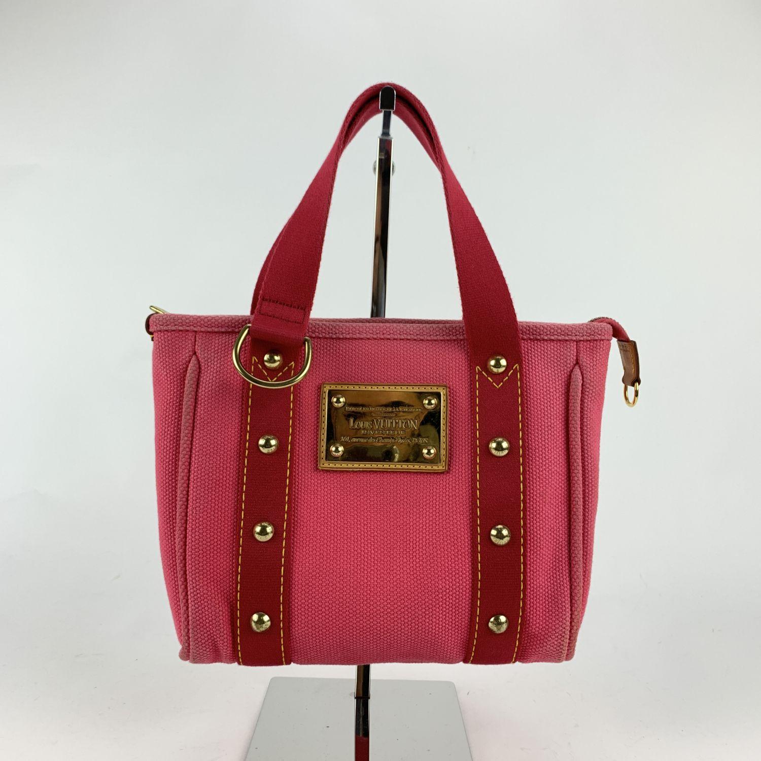 Louis Vuitton ANTIGUA PM handbag in pink canvas with red trim and handles. The line it is inspired by a nautical style infact the collection is named after the Caribbean island, known for its yacht races. This is the Small sized version (PM) of the