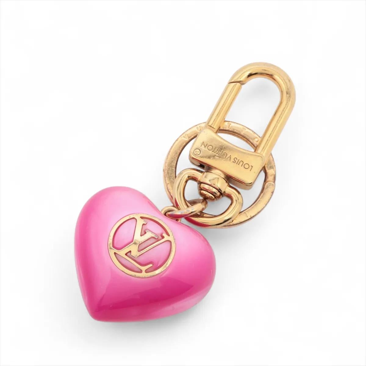 Il charm per borsa Louis Vuitton Pink LV Heart è un accessorio giocoso e femminile che aggiunge un tocco di fascino a qualsiasi borsa. Realizzato con un design a forma di cuore, presenta le iconiche iniziali LV al centro, evidenziate da una vibrante