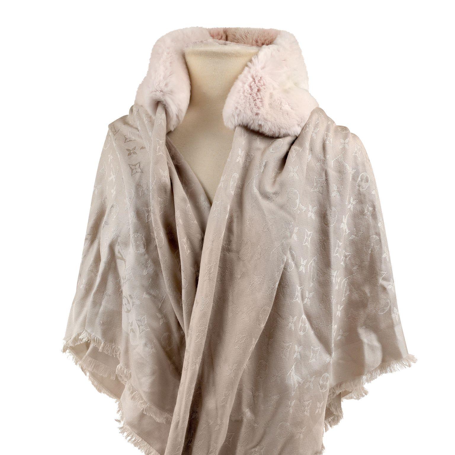 This authentic Louis Vuitton Pink Mink Monogram Shawl is a limited edition in excellent condition.  Blush pink silk blend LV monogram shawl with mink collar and floral accents.  

PBF 13833
