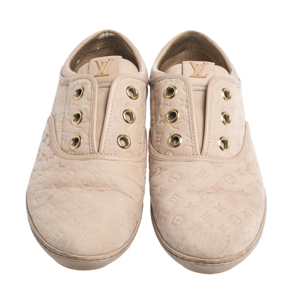 Comfort comes wrapped in these sneakers from Louis Vuitton. They are crafted from monogram embossed nubuck and they bring round toes and eyelets without laces. Set on rubber soles, these sneakers are easy to wear all day without compromising on