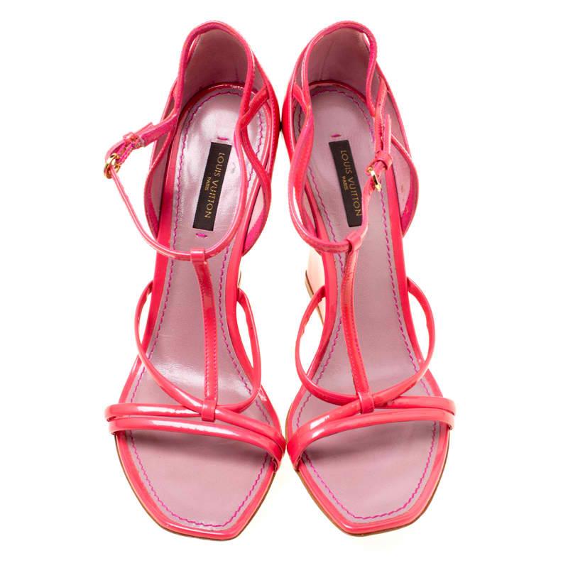 Pretty in pink, these sandals from Louis Vuitton are all you need to make an impression! They are crafted from patent leather and feature square toes. They flaunt a T-strap design and come equipped with buckled ankle straps, comfortable leather