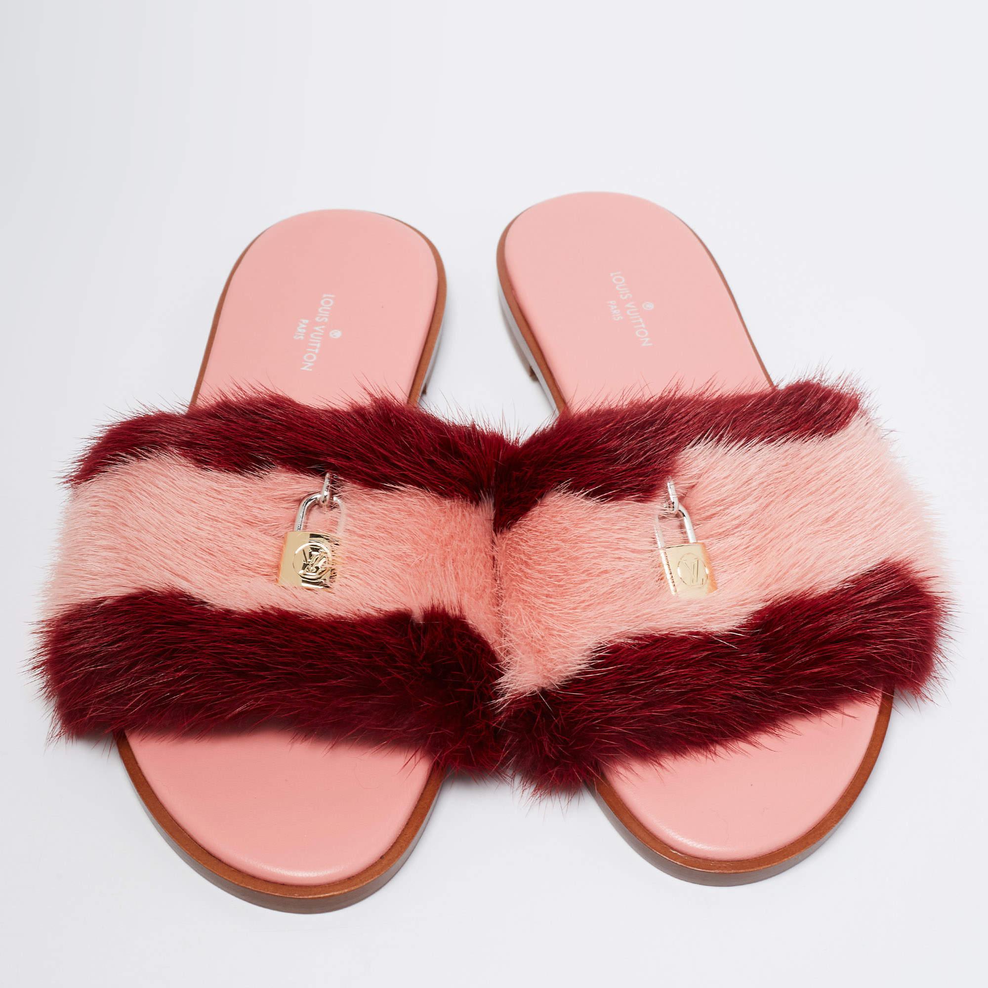 These slides by Louis Vuitton showcase a lovely design. Crafted from mink fur, the pink-red flats feature open toes and broad straps with LV locks. They come with leather-lined insoles that have the brand label. Wear them with breezy dresses for an