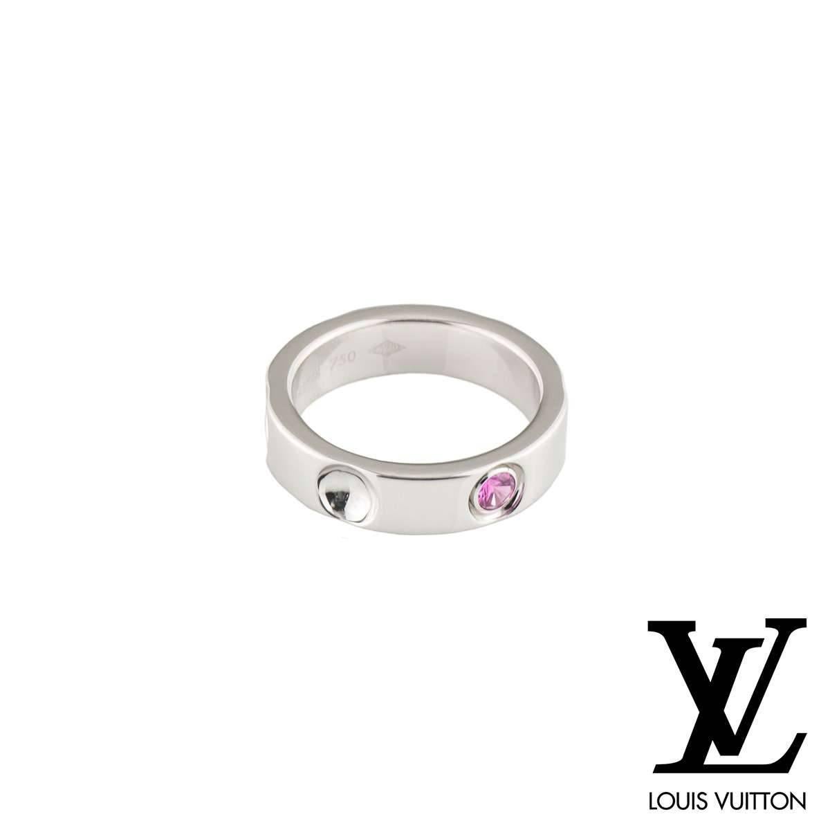 A stunning 18k white gold ring from the Empreinte collection by Louis Vuitton. The ring features 5 inverted stud motifs, one engraved with the Louis Vuitton logo. The ring is set with a single round cut pink sapphire, weighing approximately 0.10ct.