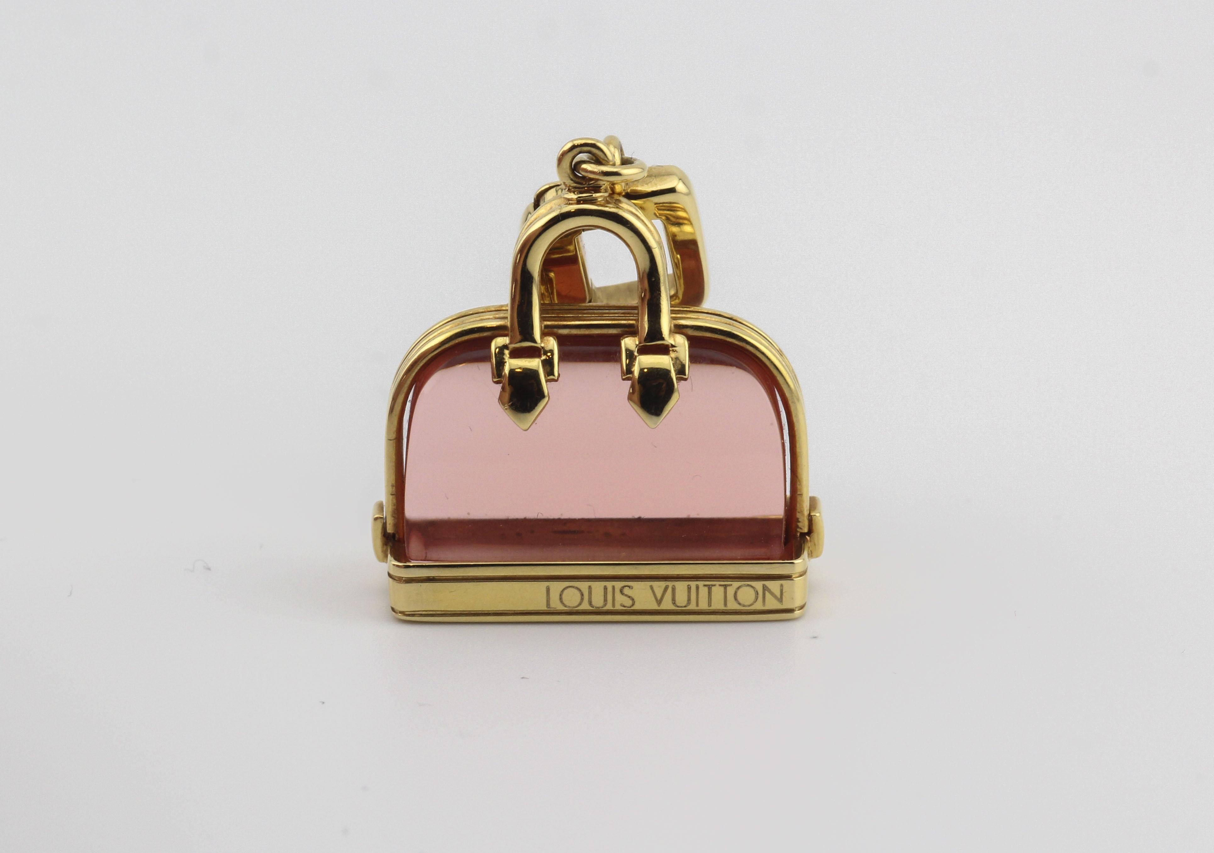 Introducing the Louis Vuitton Pink Tourmaline 18K Yellow Gold Alma Bag Charm Pendant, a luxurious and sophisticated jewelry piece that combines the iconic Louis Vuitton style with exquisite gemstones and craftsmanship. This charm pendant is a