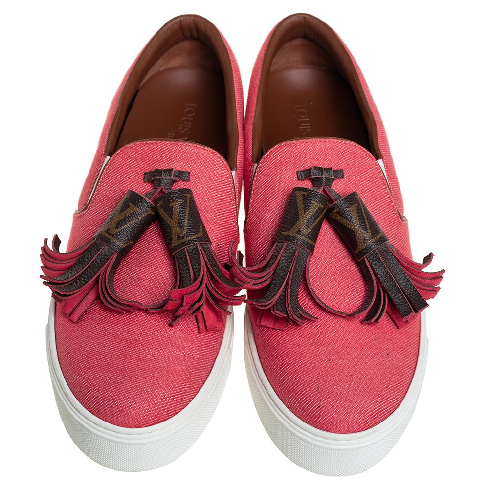 Flaunt your high style with these trendy sneakers from Louis Vuitton! They've been carefully crafted from pink twill fabric, and designed with monogram tassels on the uppers and the LV logo on the midsoles. You are sure to receive both comfort and