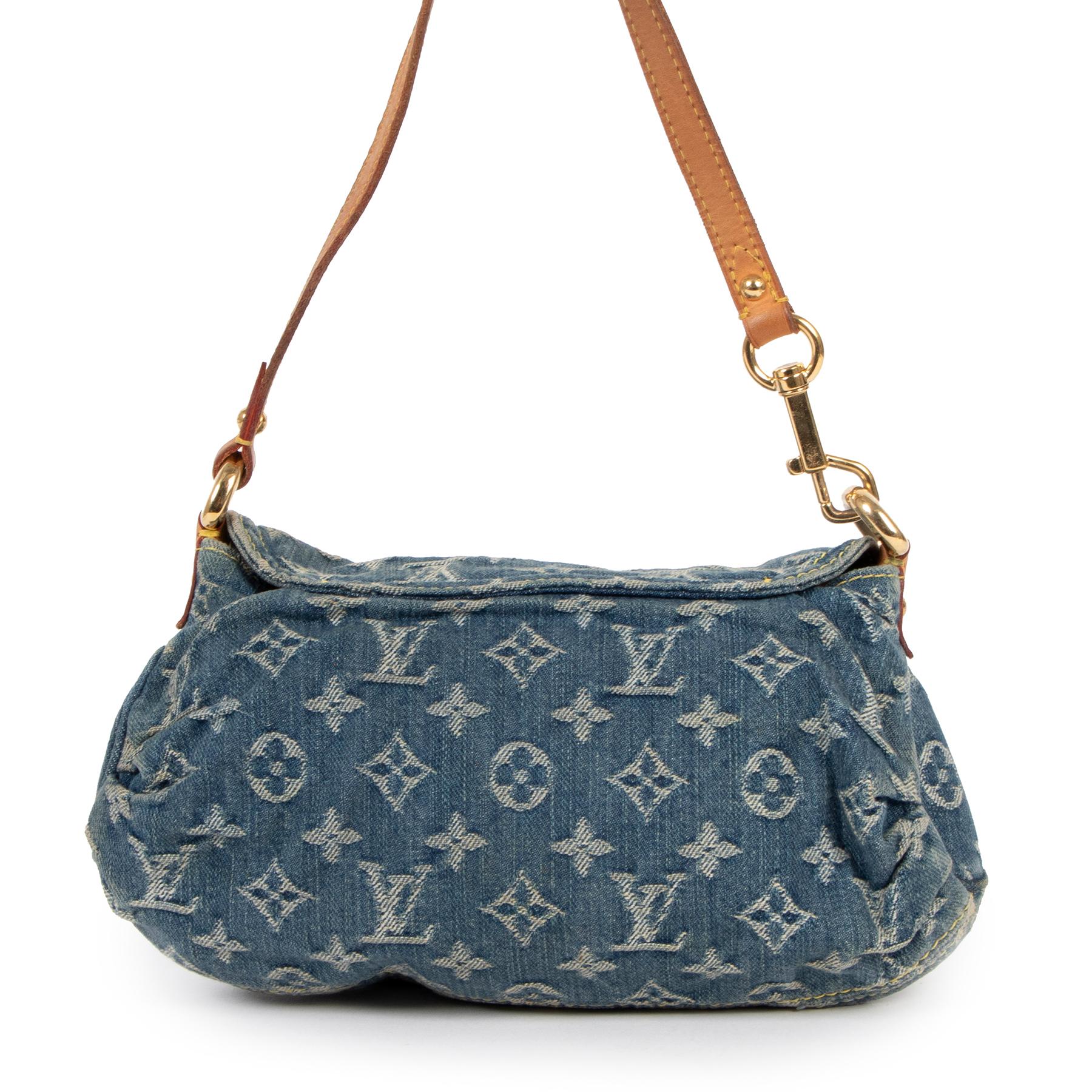 Louis Vuitton Pleaty Blue Denim Baguette
We just love this limited Louis Vuitton Pleaty Baguette bag. The bag features monogram in a lighter jeans color and a vachetta leather shoudler strap.
Open the bag up with the gold plated button to reveal a