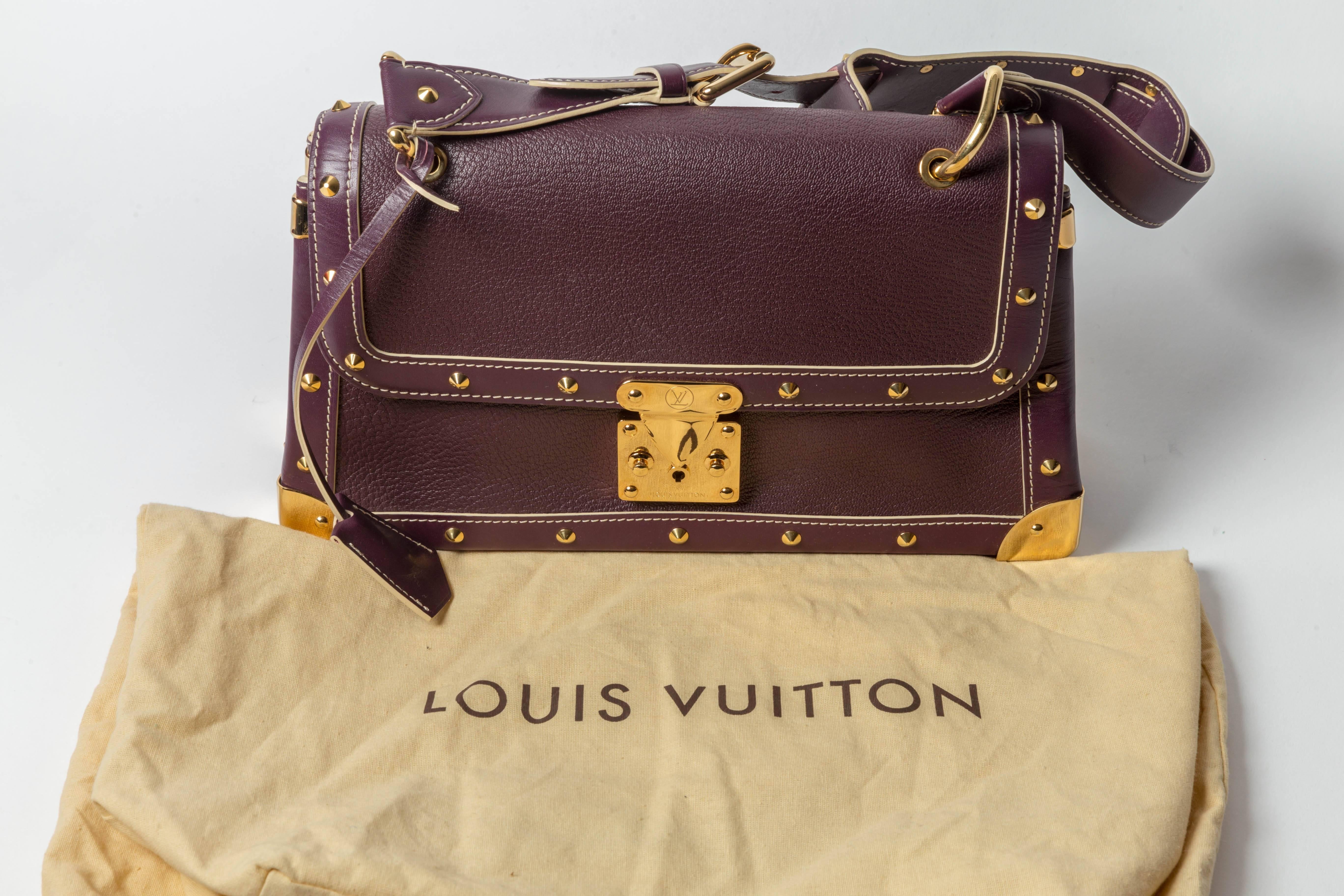 Extraordinary Louis Vuitton Goat Skin Plum Suhali le Talentueux Shoulder Bag in Excellent Condition.
One interior flap pocket.
Gold hardware is also in excellent condition with a few faint scratches.
Dust bag is included.
Shoulder strap drop 8.5