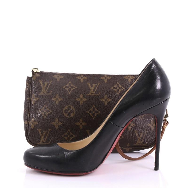 This Louis Vuitton Pochette Accessoires Monogram Canvas, crafted from brown monogram coated canvas, features a single loop shoulder strap and gold-tone hardware. Its top zip closure opens to a brown fabric interior. Authenticity code reads: AR1916.