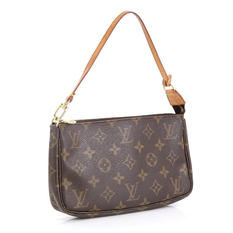 This Louis Vuitton Pochette Accessoires Monogram Canvas, crafted from brown monogram coated canvas, features a flat leather strap and gold-tone hardware. Its zip closure opens to a brown fabric interior. Authenticity code reads: VI1011. 

Estimated