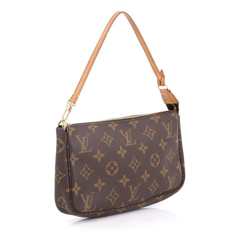 This Louis Vuitton Pochette Accessoires Monogram Canvas, crafted from brown monogram coated canvas, features a single loop shoulder strap and gold-tone hardware. Its zip closure opens to a brown fabric interior. Authenticity code reads: AR1909.