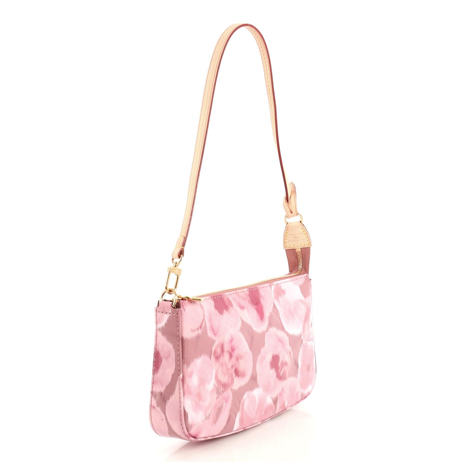 This Louis Vuitton Pochette Accessoires NM Limited Edition Monogram Vernis Ikat, crafted from pink printed monogram vernis ikat, features a single loop shoulder strap and gold-tone hardware. Its zip closure opens to a pink fabric interior with side