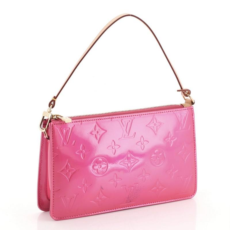 This Louis Vuitton Lexington Pochette Monogram Vernis, crafted from pink monogram vernis, features a single loop shoulder strap and gold-tone hardware. Its zip closure opens to a pink leather interior with side slip pocket. Authenticity code reads: