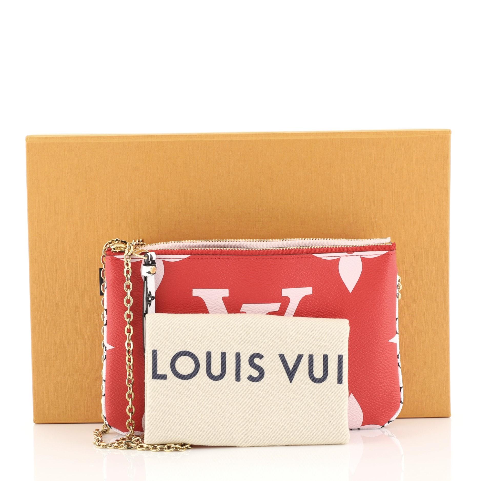 This Louis Vuitton Pochette Double Zip Limited Edition Colored Monogram Giant, crafted from red and pink monogram coated canvas, features chain link strap and gold-tone hardware. It opens to a pink microfiber interior with two zip compartments and