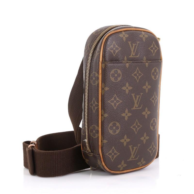 This Louis Vuitton Pochette Gange Monogram Canvas, crafted from brown monogram coated canvas, features an adjustable textile strap, exterior front pocket, and gold-tone hardware. Its all-around zip closure opens to a brown fabric interior.