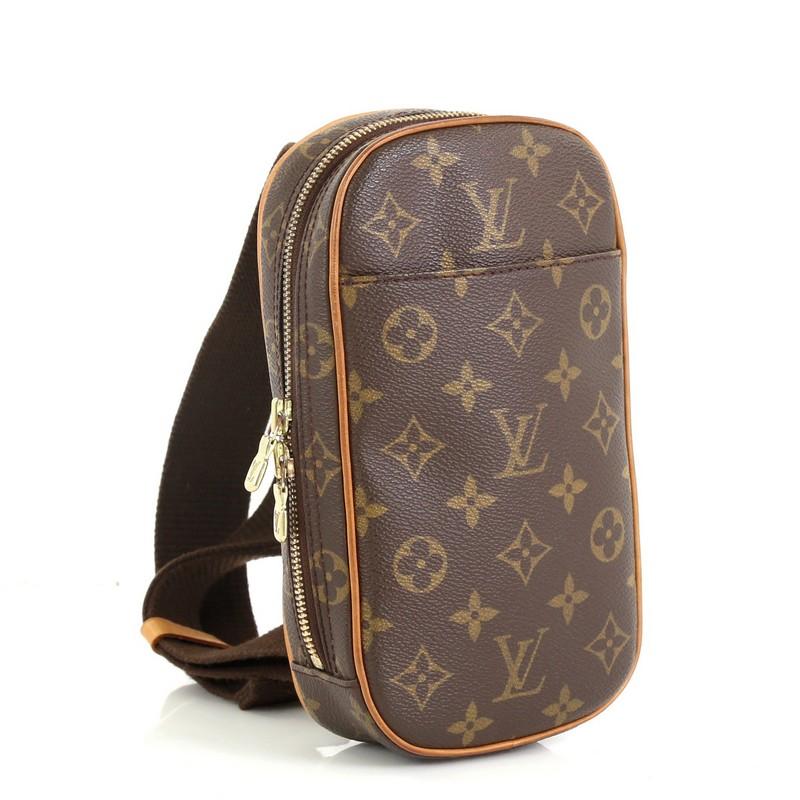 This Louis Vuitton Pochette Gange Monogram Canvas, crafted from brown monogram coated canvas, features an adjustable textile strap, exterior front pocket, and gold-tone hardware. Its zip closure opens to a brown fabric interior. Authenticity code