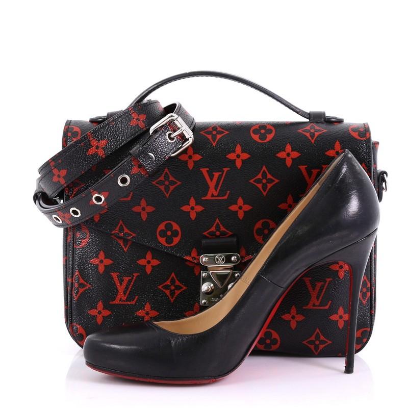 This Louis Vuitton Pochette Metis Limited Edition Monogram Infrarouge, crafted from black and red monogram infrarouge coated canvas, features a leather top handle, frontal flap, exterior back zip pocket, and silver-tone hardware. Its S-lock closure