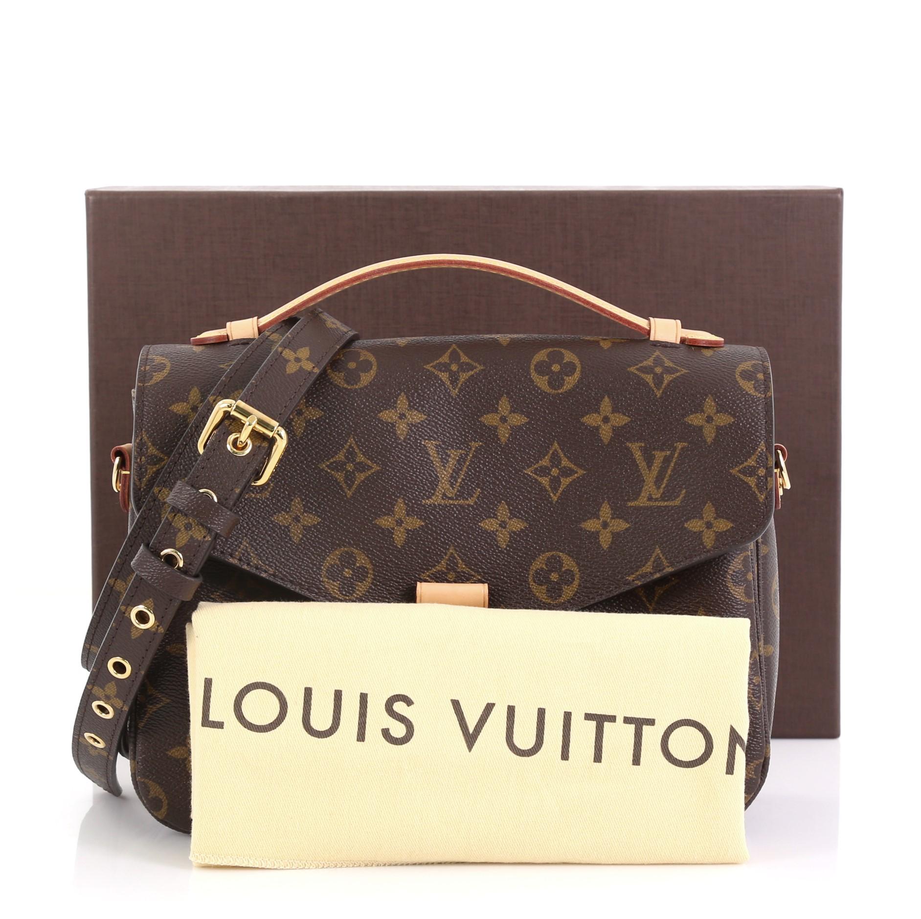 This Louis Vuitton Pochette Metis Monogram Canvas, crafted in brown monogram coated canvas, features a leather top handle, exterior back zip pocket, and gold-tone hardware. Its S-lock closure opens to a brown microfiber interior with two open
