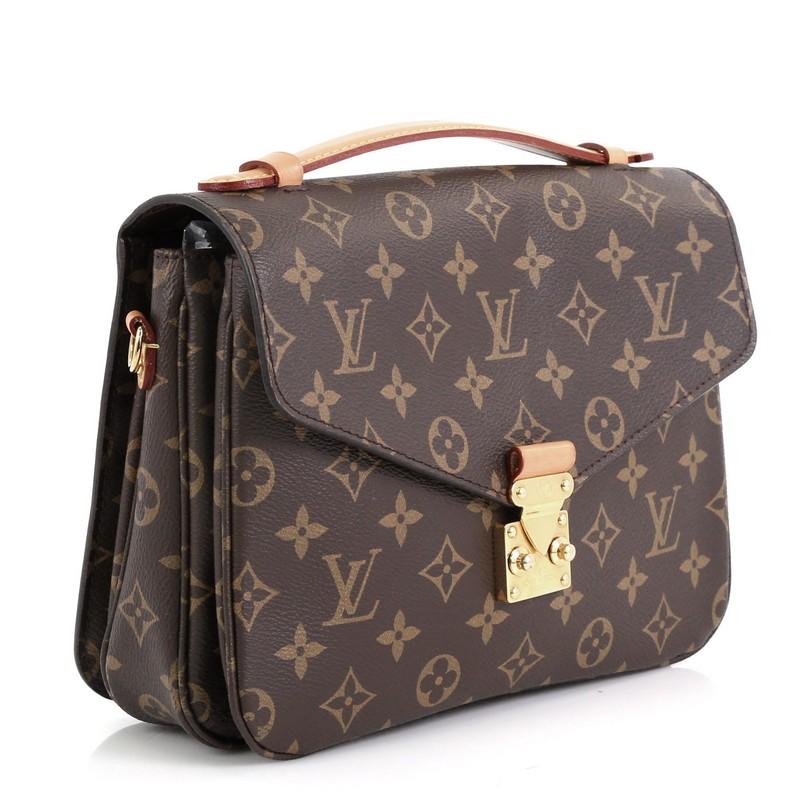 This Louis Vuitton Pochette Metis Monogram Canvas, crafted from brown monogram coated canvas, features a top leather handle, exterior back zip pocket, and gold-tone hardware. Its S-lock closure opens to a brown microfiber interior divided into three
