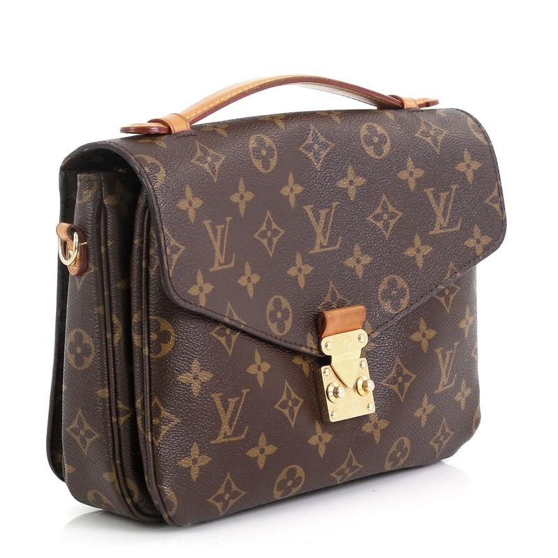 This Louis Vuitton Pochette Metis Monogram Canvas, crafted from brown monogram coated canvas, features a top leather handle, exterior back zip pocket, and gold-tone hardware. Its S-lock closure opens to a brown microfiber interior divided into three