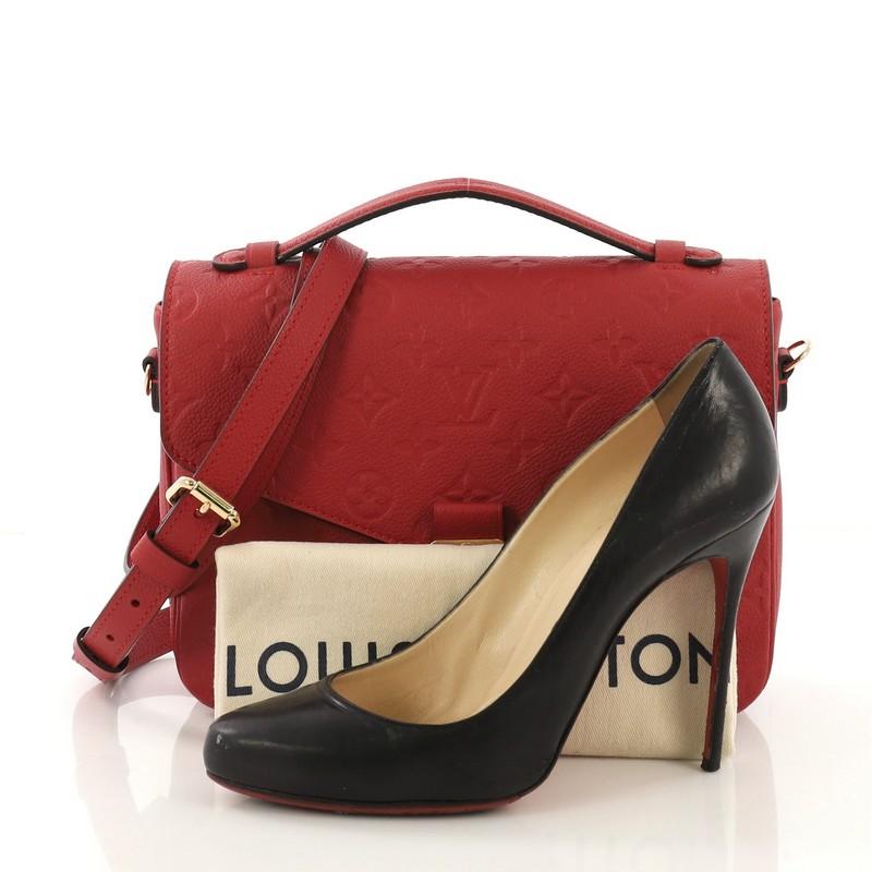 This Louis Vuitton Pochette Metis Monogram Empreinte Leather, crafted in red monogram empreinte leather, features a leather top handle, exterior back zip pocket, and gold-tone hardware. Its S-lock closure opens to a red fabric interior with two open