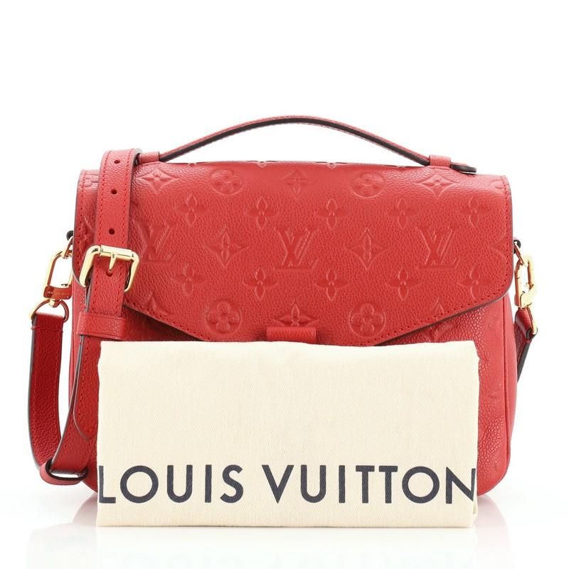 This Louis Vuitton Pochette Metis Monogram Empreinte Leather, crafted in red monogram empreinte leather, features a leather top handle, exterior back zip pocket, and gold-tone hardware. Its S-lock closure opens to a red fabric interior with two open