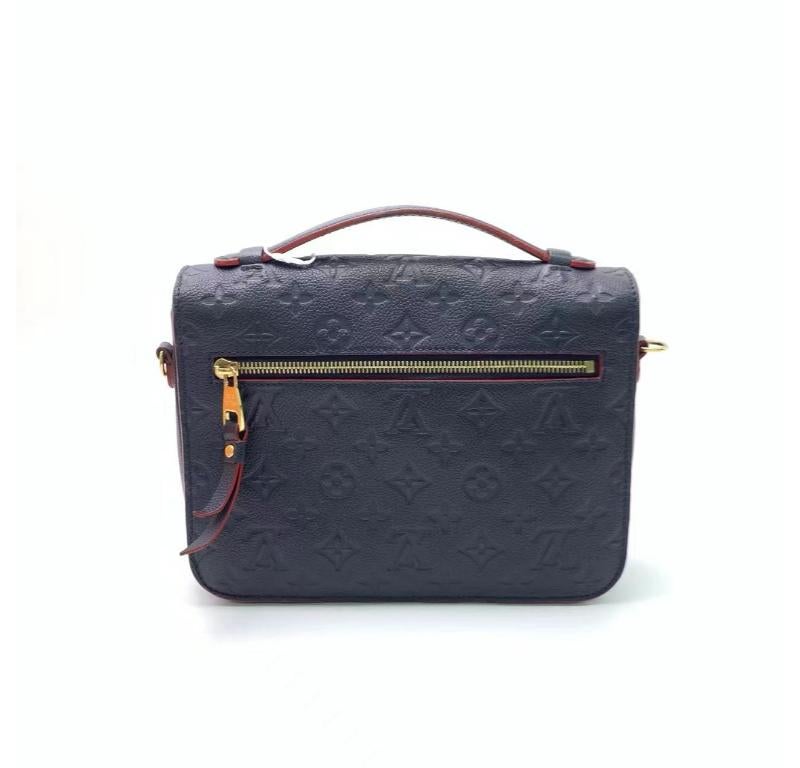 Louis Vuitton Pochette M√©tis Monogram Empreinte Leather Navy
These are professional photos of the actual bag.
  Made from supple Monogram Empreinte leather and featuring an S-lock closure, the Louis Vuitton Pochette M√©tis is a sought-after bag
