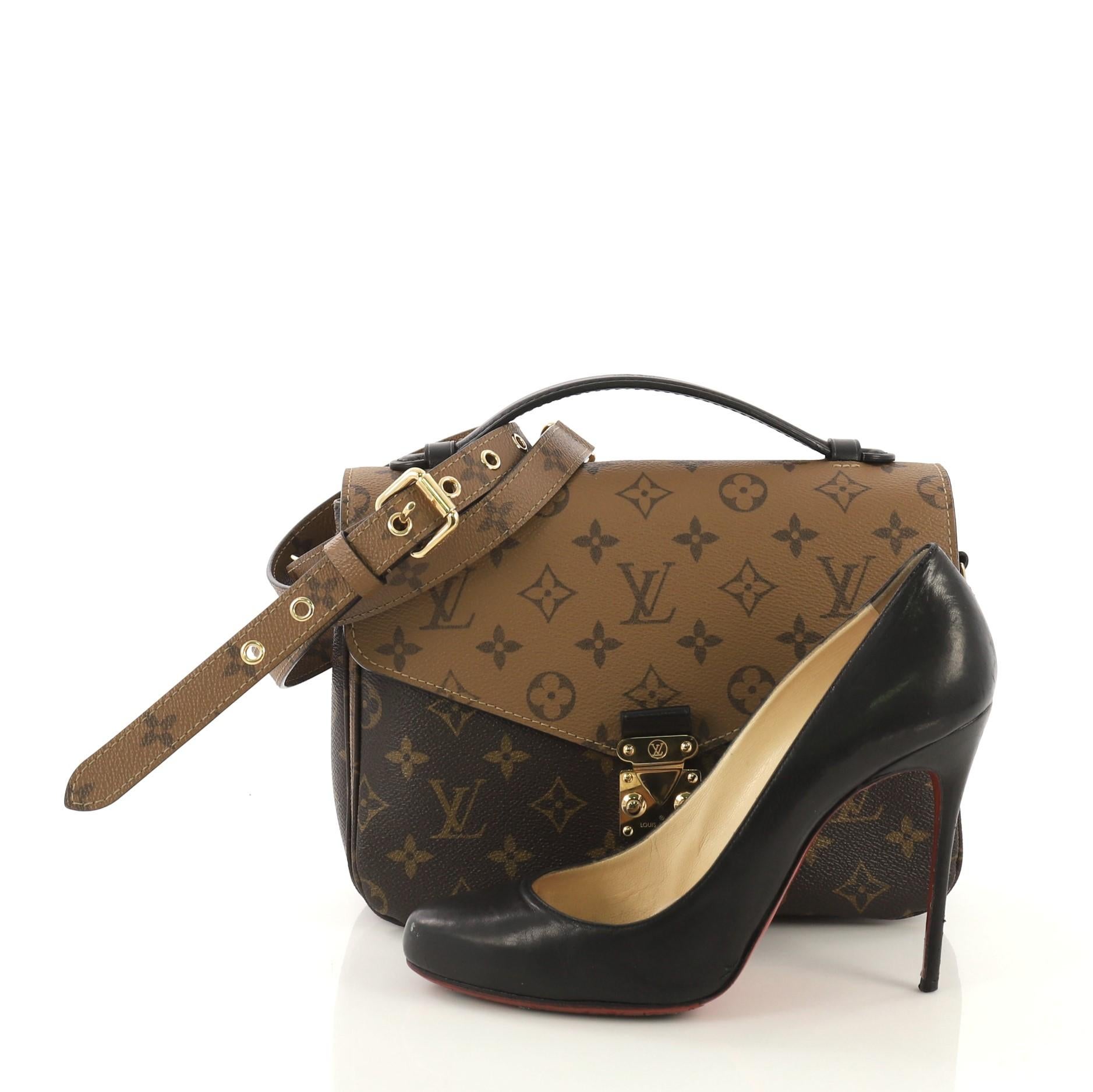 This Louis Vuitton Pochette Metis Reverse Monogram Canvas, crafted from brown reverse monogram coated canvas, features a top leather handle, exterior back zip pocket, and gold-tone hardware. Its s-lock closure opens to a black microfiber interior