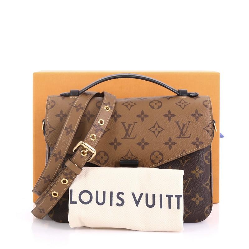 This Louis Vuitton Pochette Metis Reverse Monogram Canvas, crafted from brown reverse monogram coated canvas, features a top leather handle, exterior back zip pocket, and gold-tone hardware. Its s-lock closure opens to a black microfiber interior