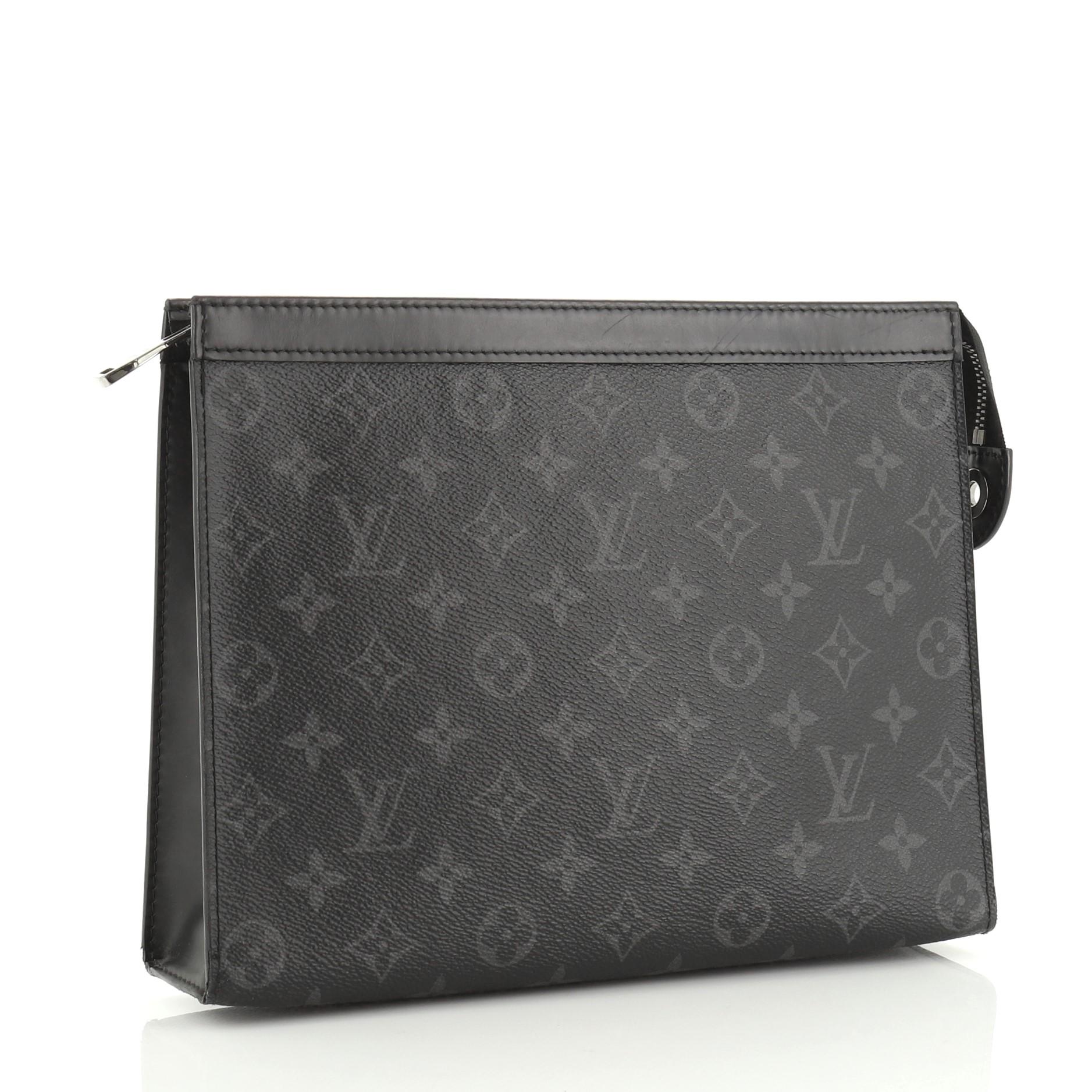 This Louis Vuitton Pochette Voyage Monogram Eclipse Canvas MM, crafted in monogram eclipse coated canvas, features leather trim and gunmetal-tone hardware. Its zip closure opens to a black fabric and leather interior with multiple card slots and