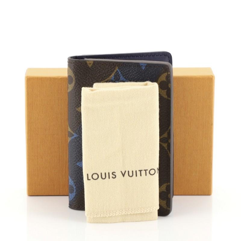 This Louis Vuitton Pocket Organizer Limited Edition Monogram Canvas, crafted from brown monogram coated canvas, It opens to a blue leather interior with multiple card slots and slip pockets. Authenticity code reads: MI1105. 

Estimated Retail Price: