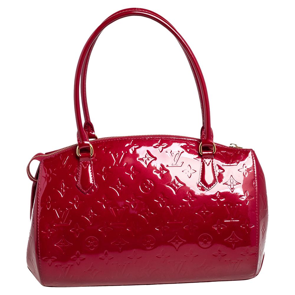 Louis Vuitton's handbags are popular owing to their high style and functionality. Crafted from beautiful red monogram Vernis, the Montana bag features dual top handles, lovely monogram charms, and gold-tone hardware. The zip-top closure opens to a