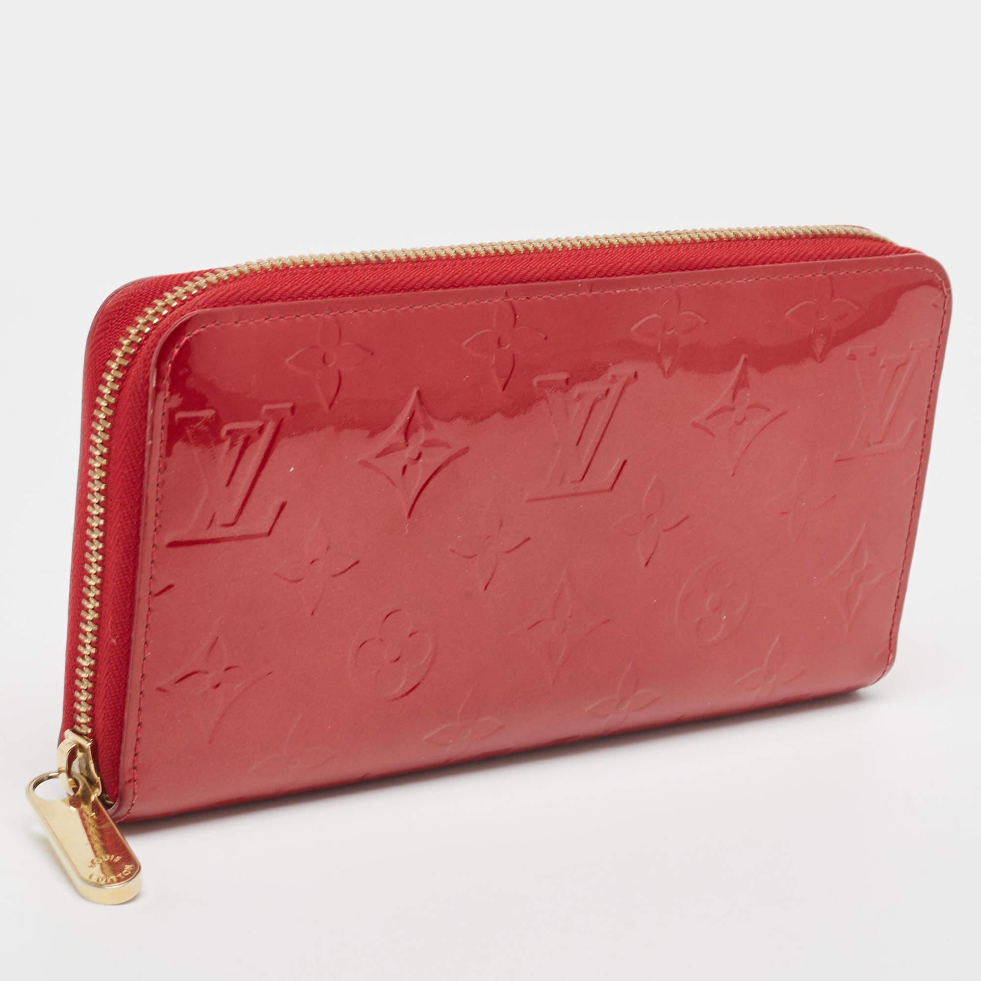 This Louis Vuitton Zippy wallet is conveniently designed for everyday use. Crafted from Pomme D’amour Monogram Vernis, the wallet has a wide zip closure that opens to reveal multiple slots, leather-lined compartments, and a zip pocket for you to