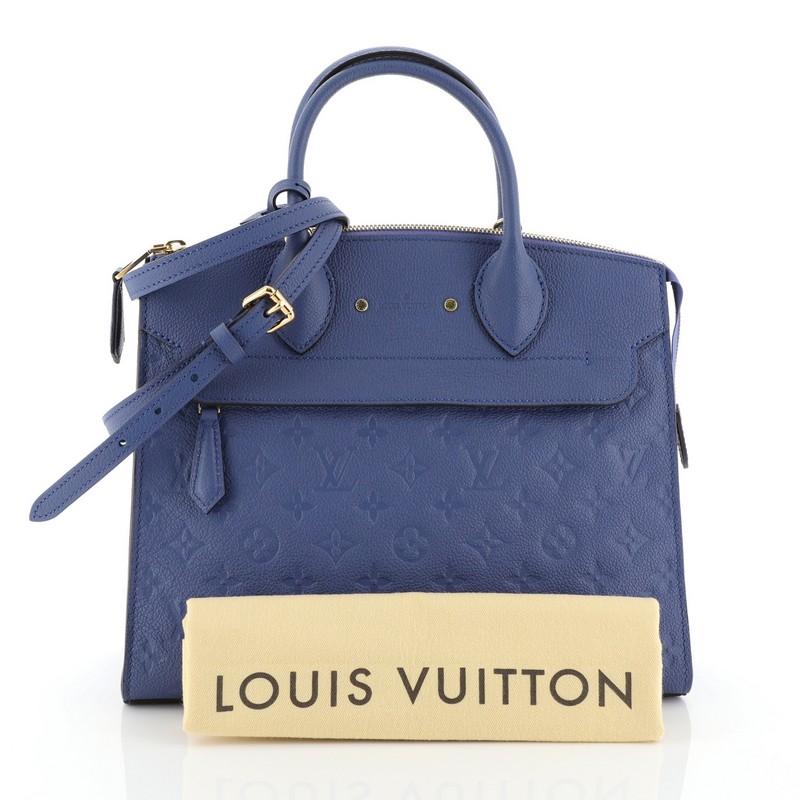 This Louis Vuitton Pont Neuf Handbag Monogram Empreinte Leather MM, crafted in blue monogram empreinte leather, features dual rolled leather handles, zip compartments at the front and back, and gold-tone hardware. It opens to a blue fabric interior.