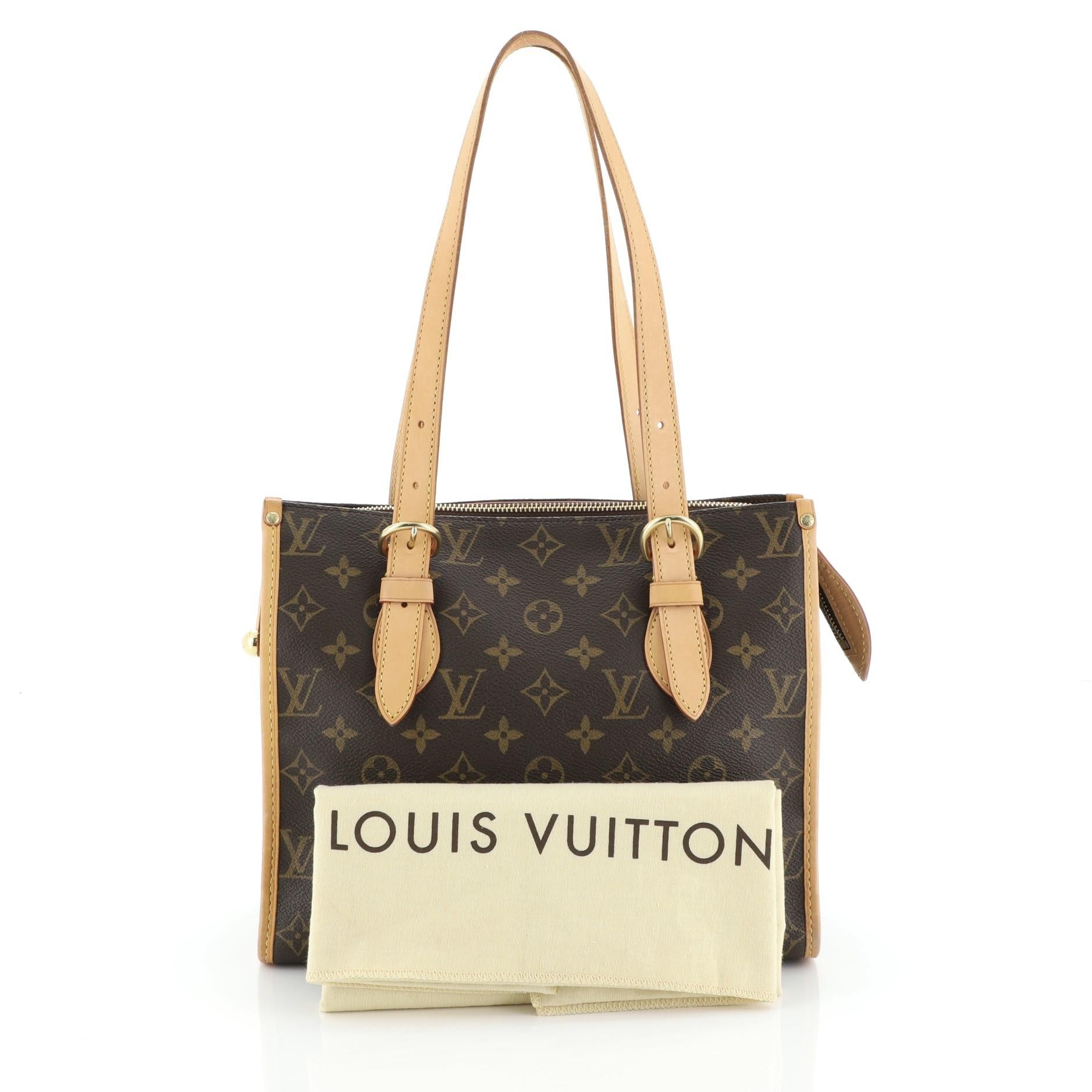 This Louis Vuitton Popincourt Tote Monogram Canvas Haut, crafted from brown monogram coated canvas, features dual leather handles, cowhide leather trim, and gold-tone hardware. Its zip closure opens to a brown fabric interior with slip pockets.