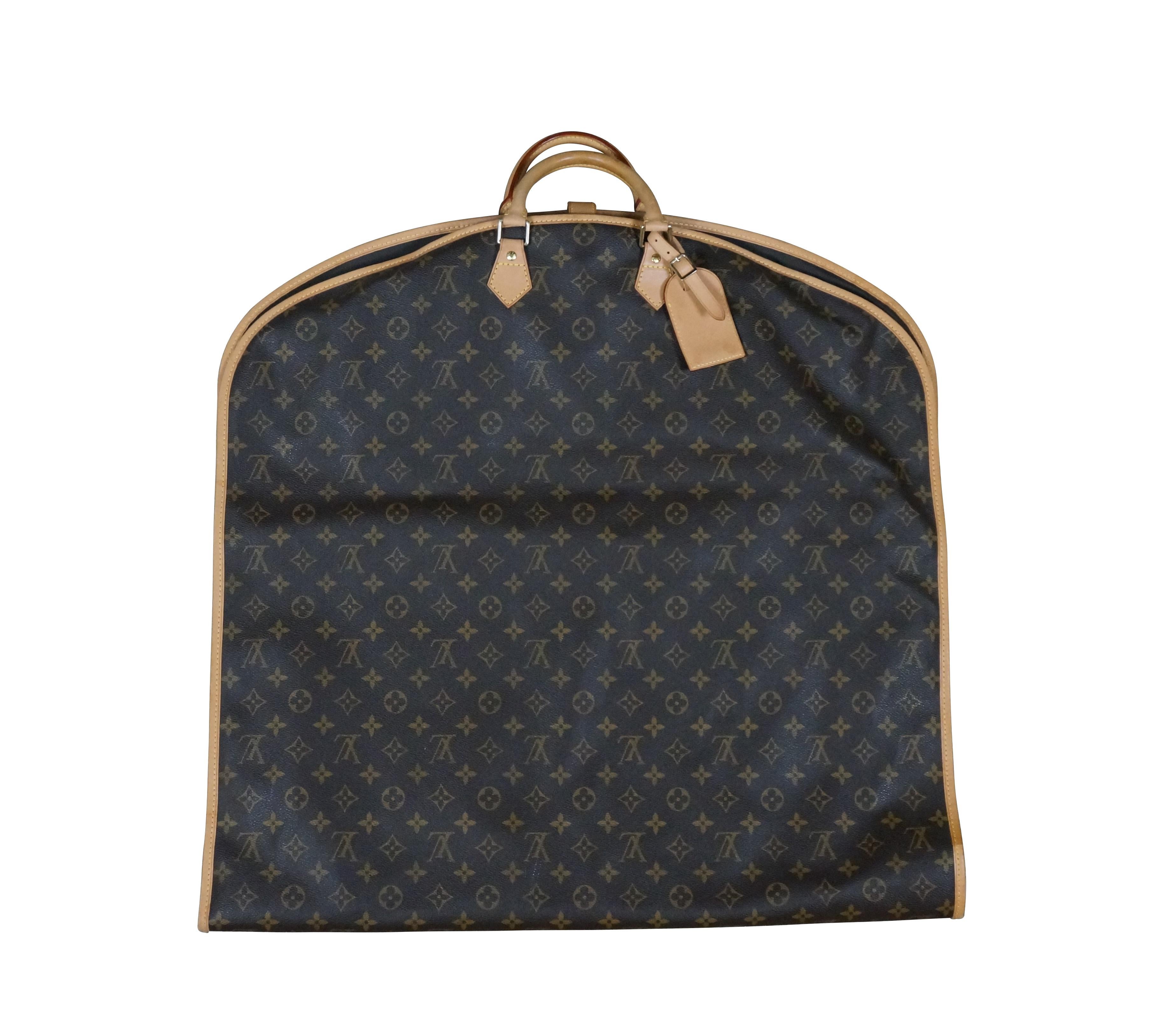 Louis Vuitton Paris Porte Avi hanging garment bag / suit cover and dust jacket. Monogram canvas with leather trim, handles, and removable luggage tag; gold hardware. Snap closure. Nylon zippered interior. Includes four hangers (internal rod fits