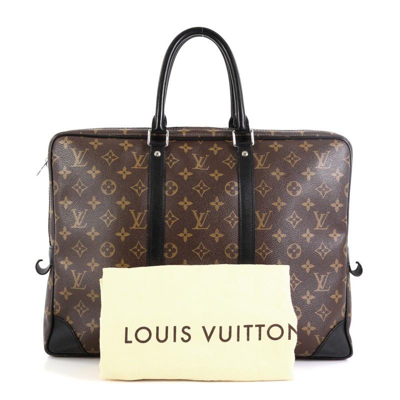 This Louis Vuitton Porte-Documents Voyage Bag Macassar Monogram Canvas, crafted from brown monogram coated canvas, features dual rolled handles, leather trim, and silver-tone hardware. Its zip closure opens to a purple fabric interior. Authenticity