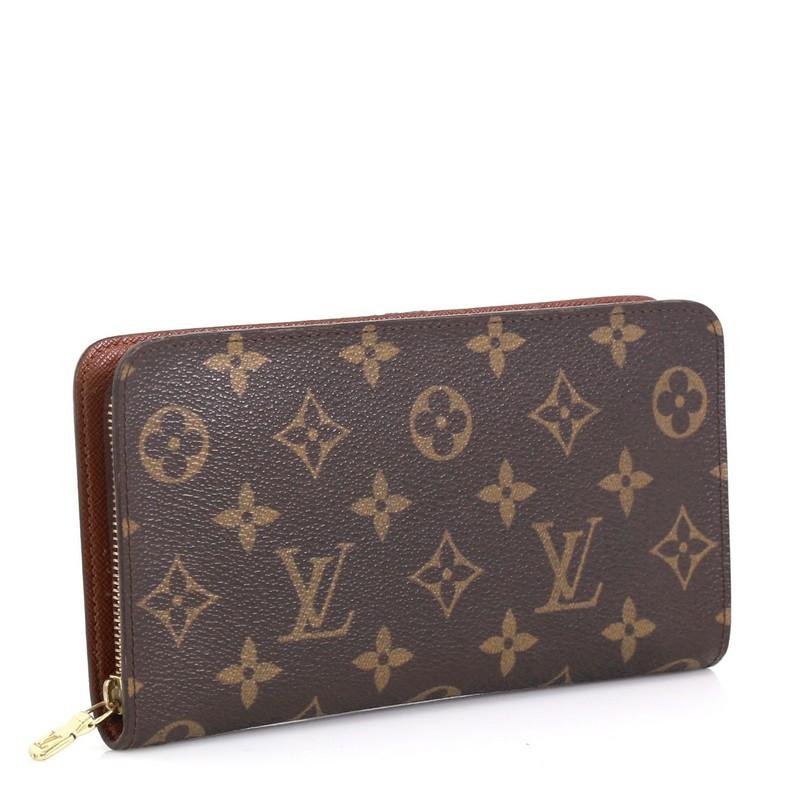 This Louis Vuitton Porte-Monnaie Wallet Monogram Canvas, crafted in brown monogram coated canvas, features gold-tone hardware. Its zip-around closure opens to a brown leather interior with a center zip pocket and side slip pockets. Authenticity code