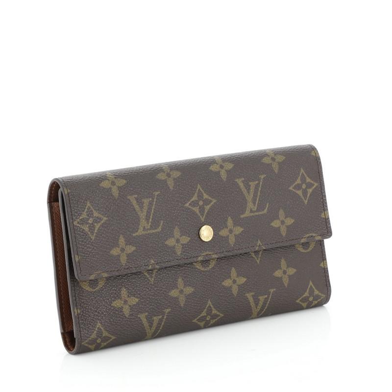 This Louis Vuitton Porte Tresor International Wallet Monogram Canvas, crafted from brown monogram coated canvas, features gold-tone hardware. Its snap closure opens to a brown leather interior with multiple card slots, long flat pockets, coin pocket