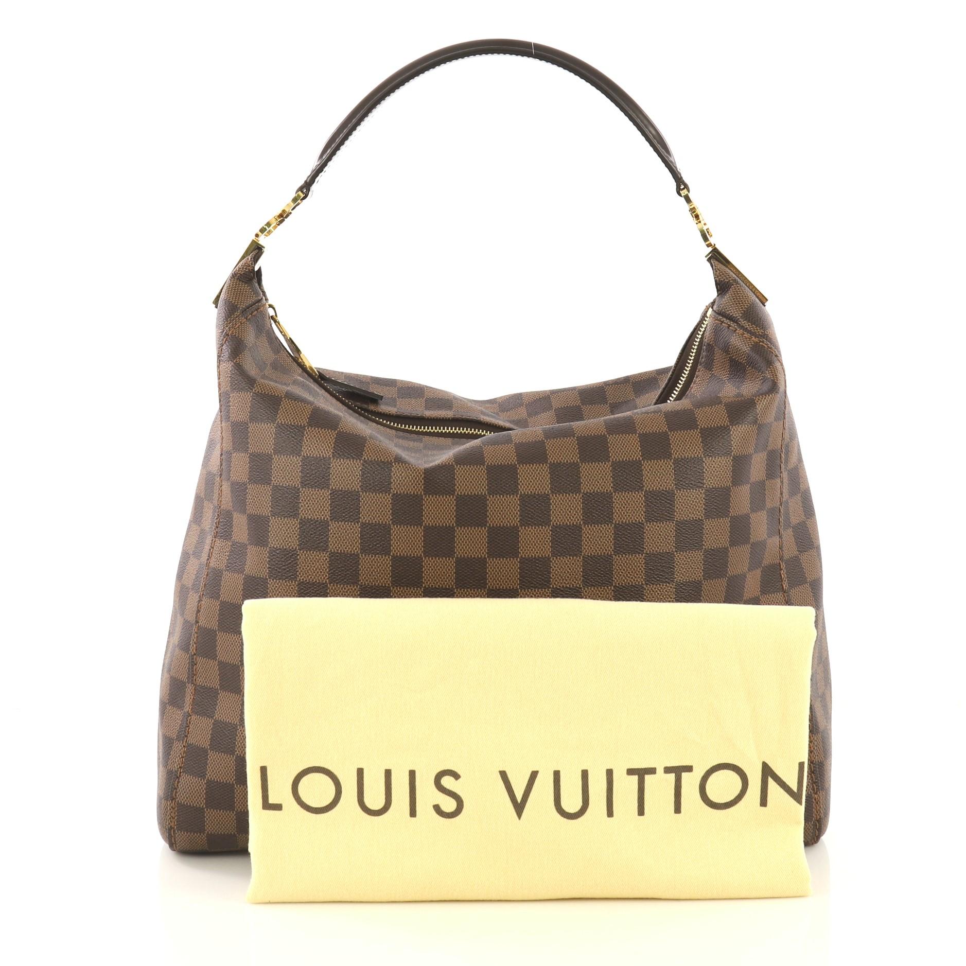 This Louis Vuitton Portobello Handbag Damier GM, crafted in damier ebene coated canvas, features single looped leather handle and gold-tone hardware. Its zip closure opens to a brown microfiber interior with side zip and slip pockets. Authenticity